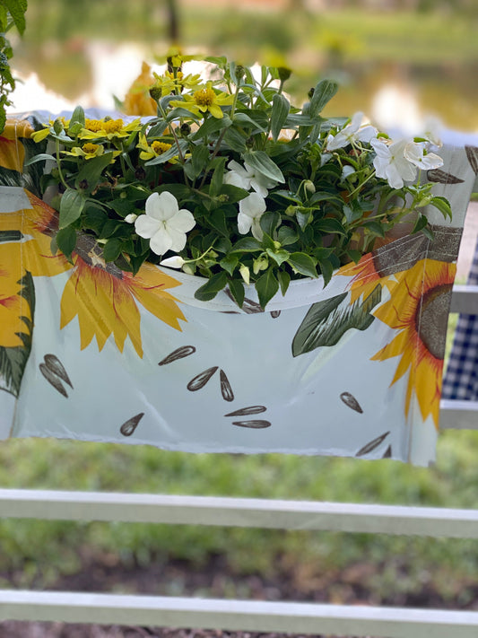 white with sunflowers railing planter for flowers, plants and herbs like a saddle bag and hangs from the railing of a patio, balcony, deck or terrance.