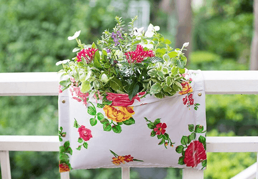 White Floral railing planter for flowers, plants and herbs like a saddle bag and hangs from the railing of a patio, balcony, deck or terrance.