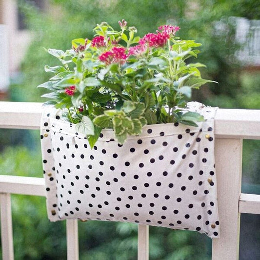 White with black polkadots railing planter for flowers, plants and herbs like a saddle bag and hangs from the railing of a patio, balcony, deck or terrance.